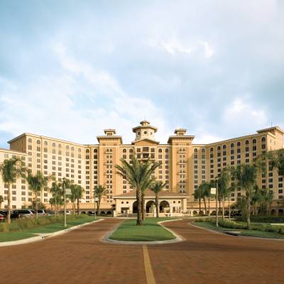 a large building with a tower in the middle of a road