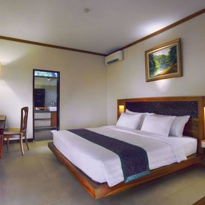 a bedroom with a bed and desk in a room