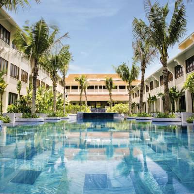a house with a pool in front of a building