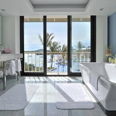a large white tub next to a window