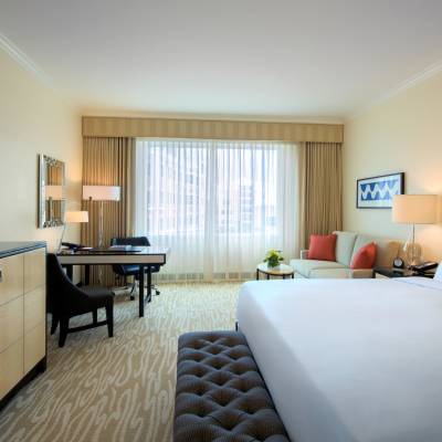 a hotel room with a bed and a flat screen tv