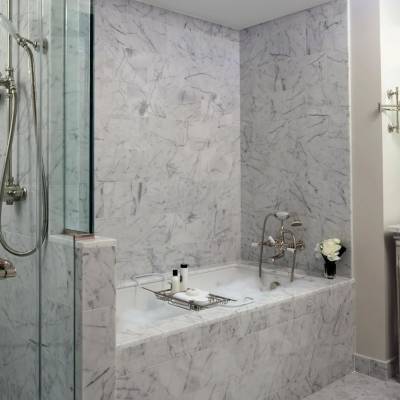 a large white tub sitting next to a sink