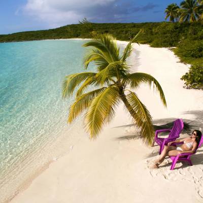 a person riding on top of a beach