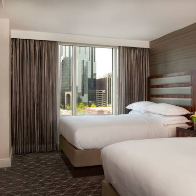 a bedroom with a large bed in a hotel room
