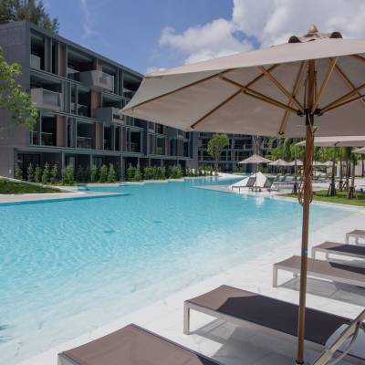 a house with a pool in front of a building