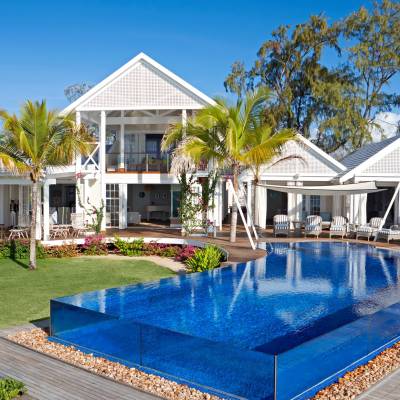 a house with a pool in front of a building