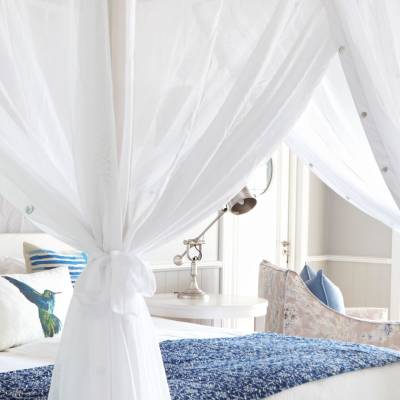 a bedroom with a bed and a curtain