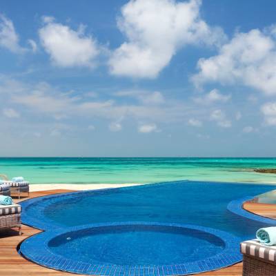 a group of lawn chairs sitting on top of a beach