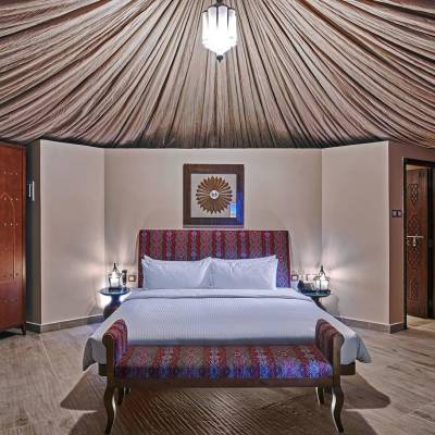 a bedroom with a large bed in a room