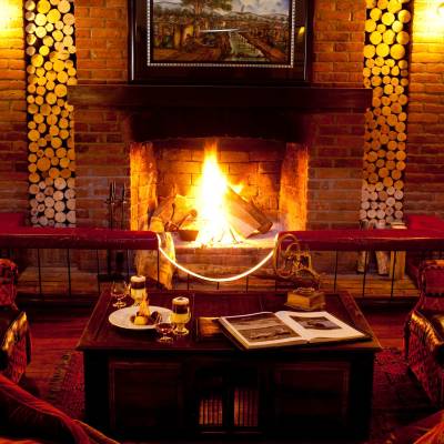 a fire place and a glass of wine