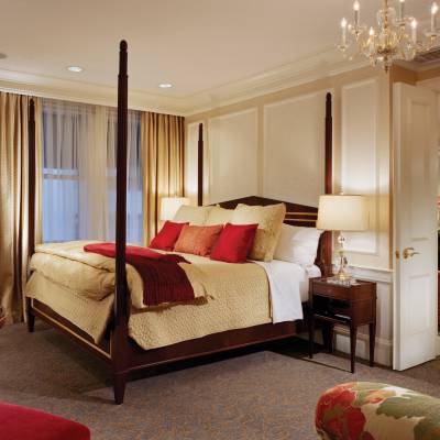 a bedroom with a large red chair in a room
