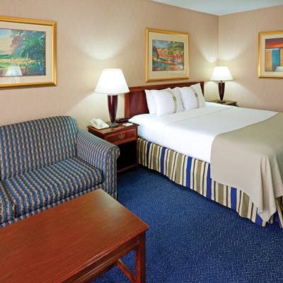 a hotel room with a bed and chair