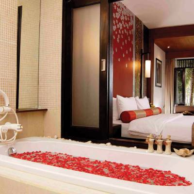 a bedroom with a bed and a mirror