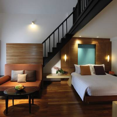 a bedroom with a bed and desk in a room