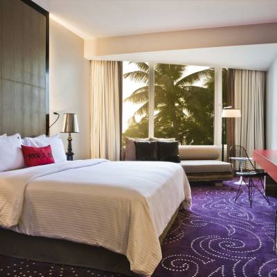 a bedroom with a large bed in a hotel room
