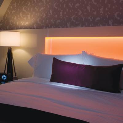 a bedroom with a large bed in a dark room