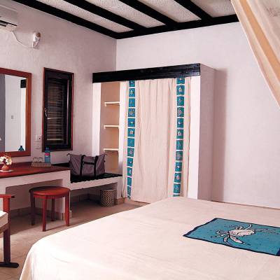 a bedroom with a bed and desk in a room
