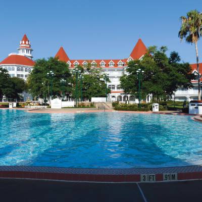a large pool of water with Disney's Grand Floridian Resort & Spa in the background