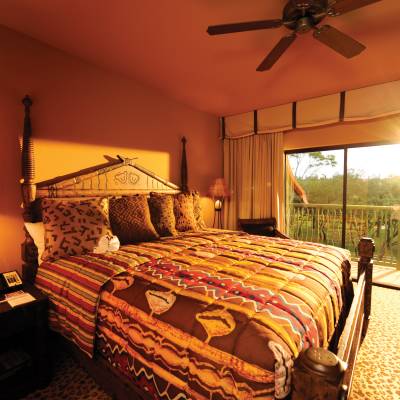 a bedroom with a large bed in a hotel room
