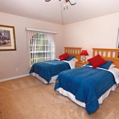 a bedroom with a bed and desk in a room