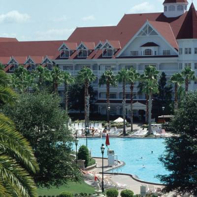 a group of palm trees with a building in the background