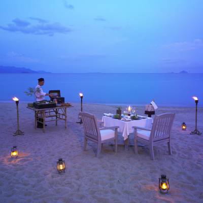 a group of people sitting in a chair next to a body of water