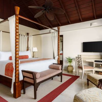 a bedroom with a bed and a chair in a room