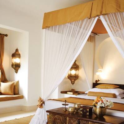 a bedroom with a bed and a mirror