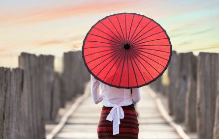 a person holding a colorful umbrella