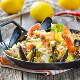 Tasty Spanish paella with seafood and chicken breast