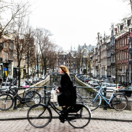 Amsterdam Cyclist traveling over a bridge