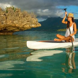 Young beautiful girl riding on clear waters of the Indian Ocean of Mauritius