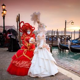 Enchanting Travels Italy tours Sunrise in Venice Italy in front of Gondolas on the Grand Canal Beautiful costumed women