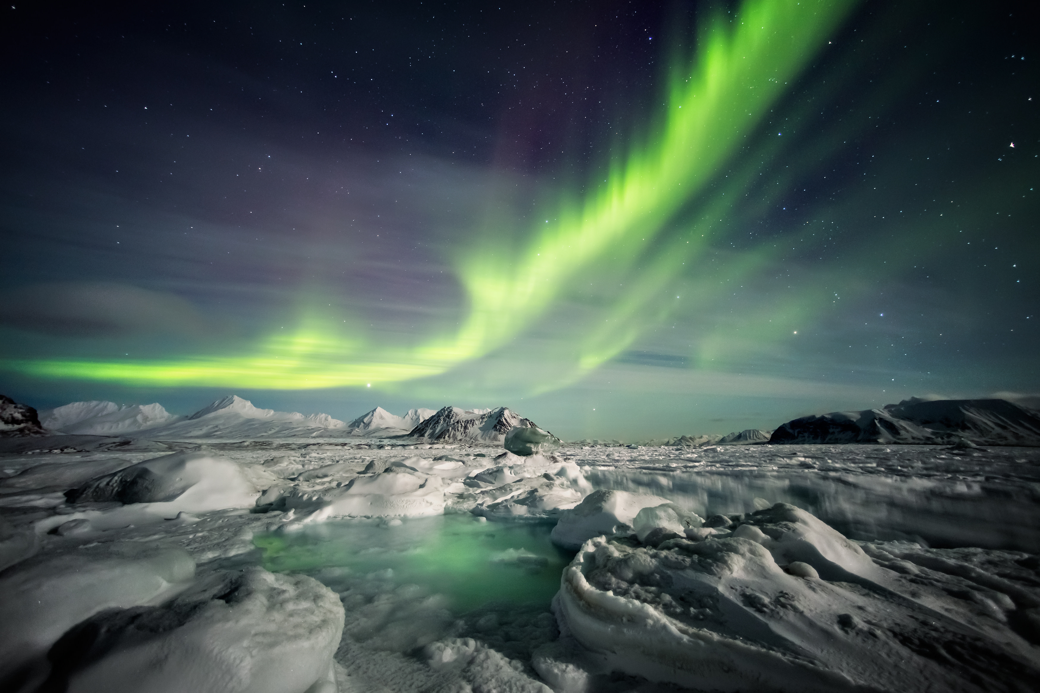 Northern Lights above the frozen Arctic fjord Best time to visit Canada