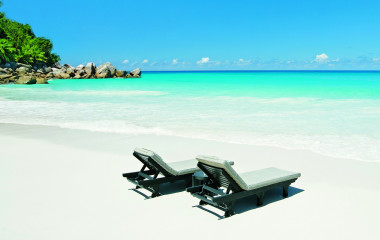 Deckchairs at the beach of Praslin Island, Seychellen