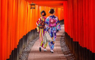 Top 10 temples in Japan - Women in traditional japanese kimonos walking at Fushimi Inari Shrine in Kyoto, Japan