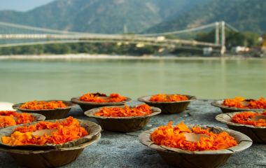 Enchanting Travels India Tours Puja flowers offering for the Ganges river in Rishikesh, India