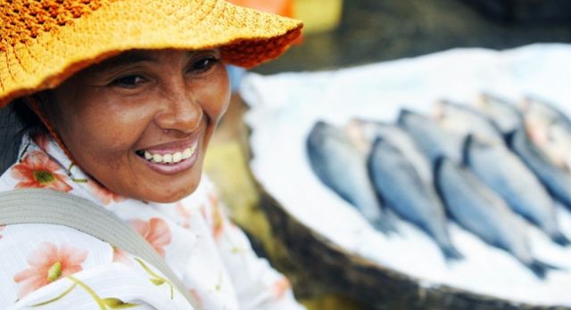 Indigenous Cambodian woman selling fish in a market, Asia
