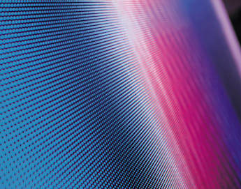 A close-up of a digital screen displaying a vibrant gradient pattern of small blue and red dots. The dots create an abstract, wave-like design as the colors blend seamlessly together, giving a sense of movement and fluidity. The focus is on the texture of the pixels.