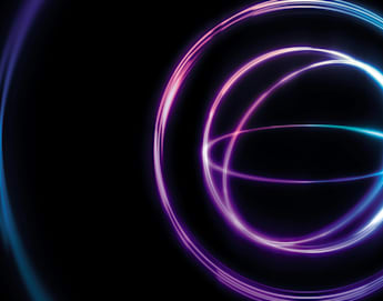 Abstract image featuring glowing neon rings in shades of purple, pink, and blue against a black background. The rings create an ethereal and dynamic visual effect, evoking a sense of motion and modernity.