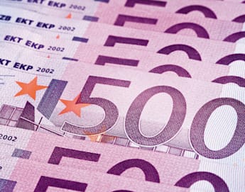 A fanned-out stack of 500 euro banknotes, arranged neatly in a horizontal pattern. The banknotes feature various security elements, including watermarks and holograms, and are predominantly purple in color.