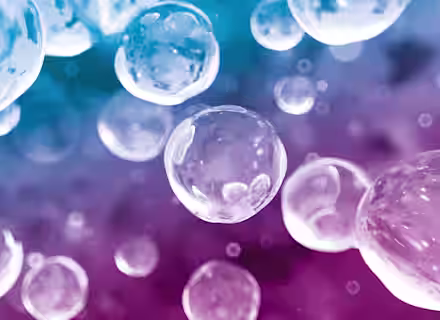 Transparent bubbles of various sizes float against a gradient background transitioning from blue at the top to purple and pink at the bottom, creating an abstract and dreamy effect.