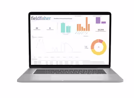 A laptop displays a data breach manager reporting dashboard with bar, line, and pie charts, showing statistics like total breaches, open investigations, and notifications, branded with the fieldfisher logo.