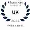 Certificate with a laurel wreath design, featuring the text "Chambers Ranked in UK 2025 Eman Hassan" in blue.