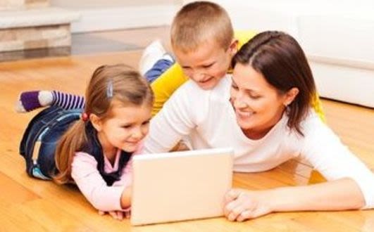 Carer and two children looking at a tablet