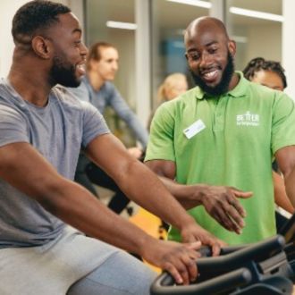 Gym instructor helping member at Vauxhall leisure centre
