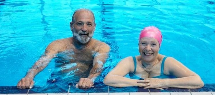 adults over 60 enjoying a swimming session