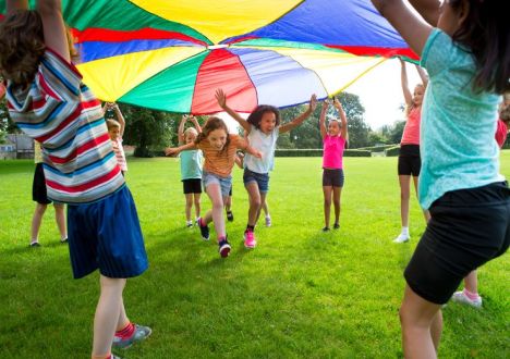 An image of children playing Parachute games