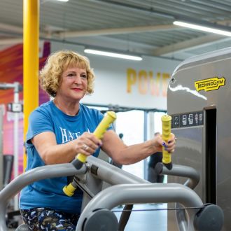 An image of a senior member on a resistance rowing exercise machine.