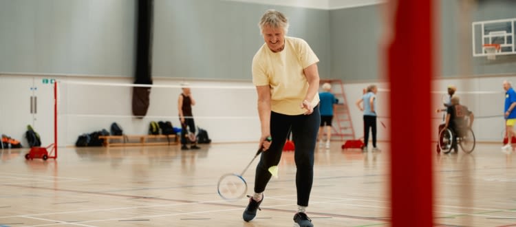 Senior lady playing badminton